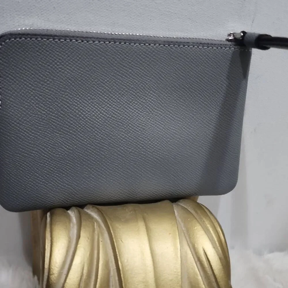 Coach Corner Zip Wristlet in a grey crossgrain leather.